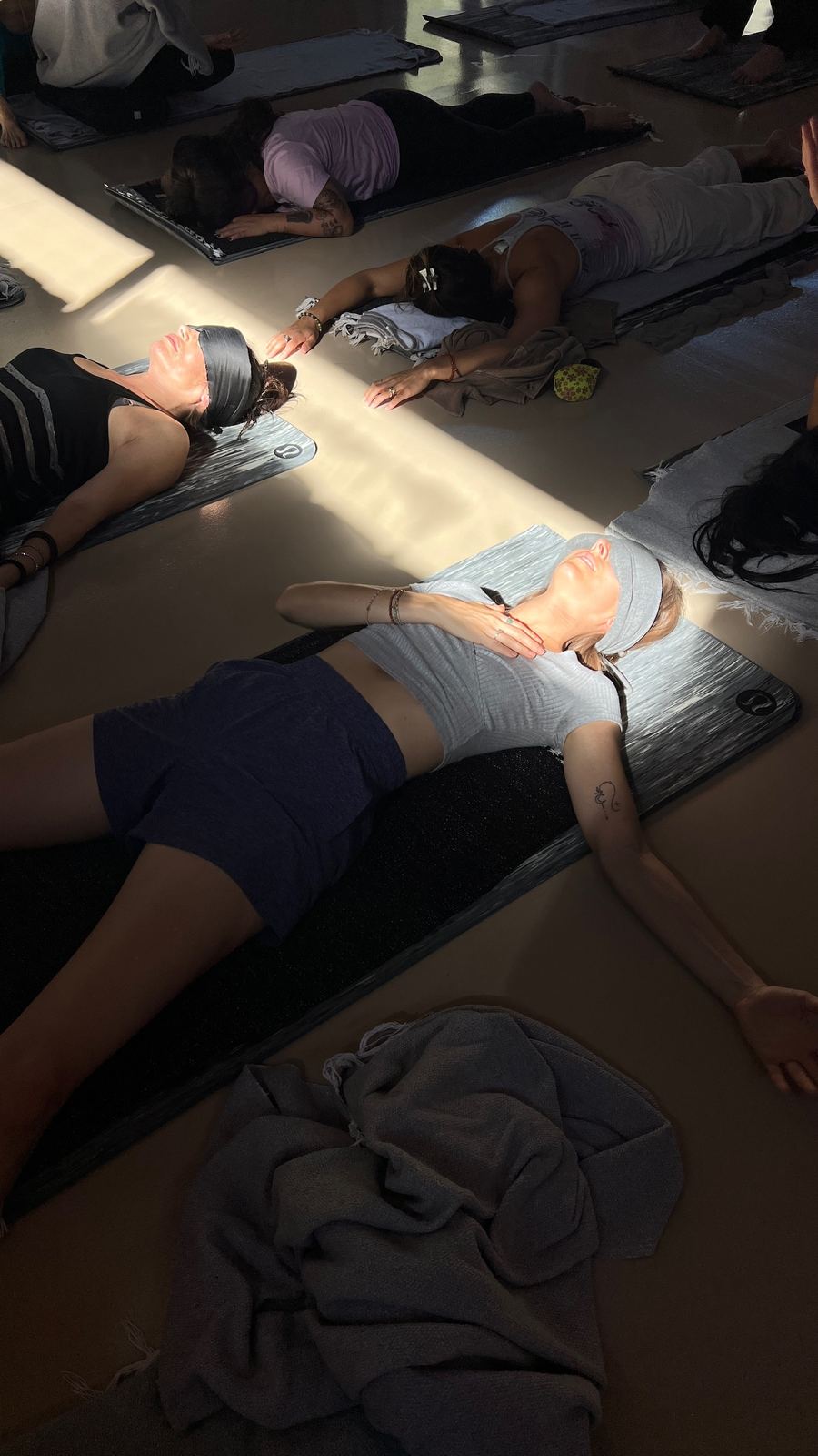 A Kundalini Activation group resting in stillness as light fills the room